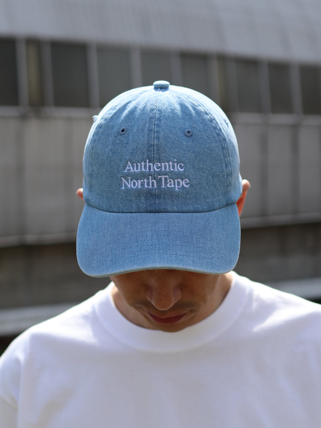 HOKKAIDOGRAPHY Authentic North Tape ロープロファイルキャップ（デニムブルー）。春夏らしい爽やかな風合いのデニム素材に「真実の北の記録」を意味する刺繍をあしらったカジュアルな帽子。