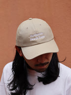 HOKKAIDOGRAPHYのAuthentic North Tape ロープロファイルキャップ（クリーム）。柔らかなコットンツイル生地に、高密度なロゴ刺繍が映えるクリーンで上品な帽子。